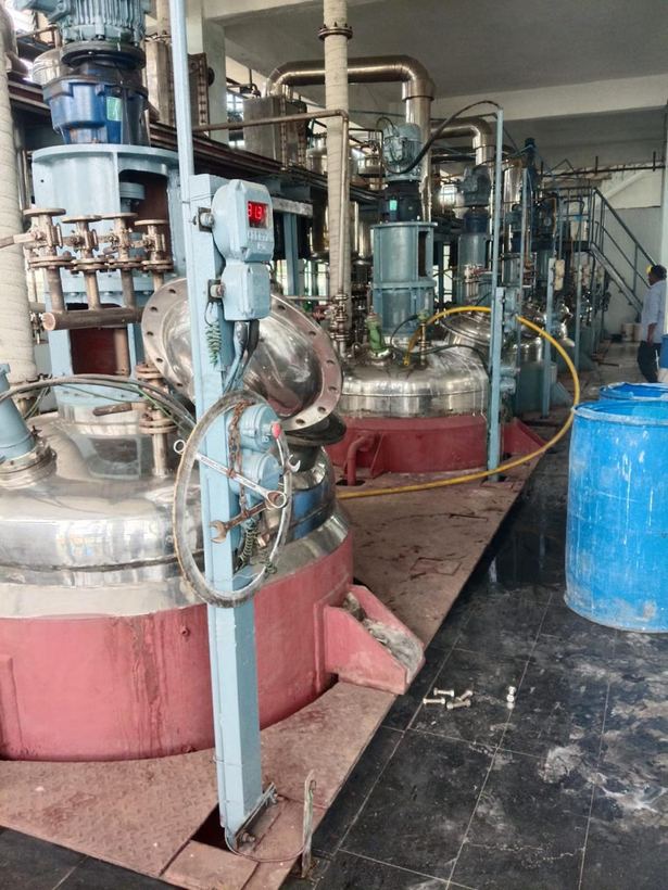 Line of stainless steel reactors along the production bay